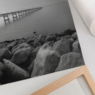 Poster para cozinha com paisagem tranquila de ponte em praia rochosa sob céu cinzento