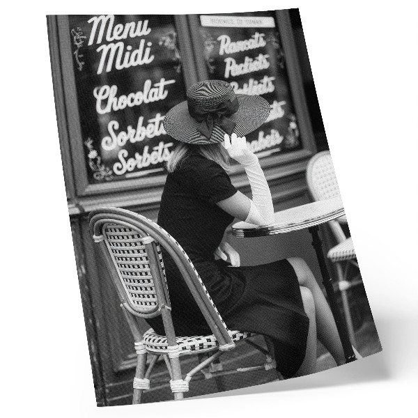 Arte de parede Uma mulher usando chapéu sentada à mesa em um café.