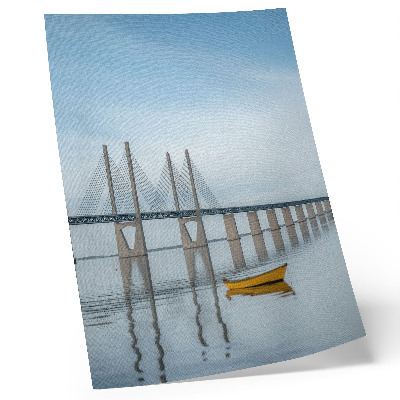 Arte de parede Uma ponte contra o céu e a água com um barco amarelo