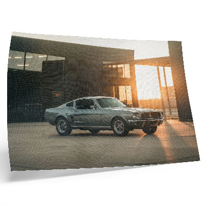 Poster em tela Um carro clássico com um cenário arquitetônico.