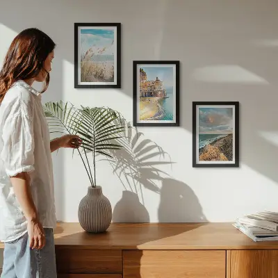 Conjunto de 3 quadros decorativos com paisagens litorâneas de praia, cidade e falésias