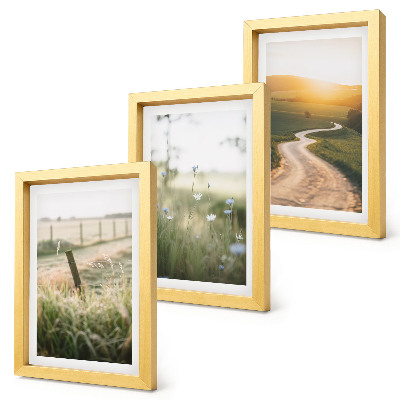 Conjunto de molduras com imagens Paisagem com um prado, estrada e pôr do sol